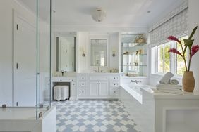 all white bathroom with blue and white tile