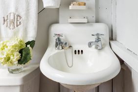 Small bathroom with white walls and old sink