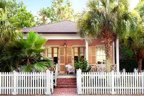 Pink Cottage Among Palm Trees in Pass Christian, MS