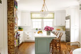 White Kitchen with Green Island and Exposed Brick Wall