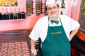 Gregory Cohen in his candymaking shop with a pan of candy canes