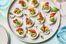 Southern Living Pesto Deviled Eggs on a platter to serve garnished with more basil 