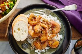 Southern Living Reid Family Barbecue Shrimp on a plate to serve with bread and rice