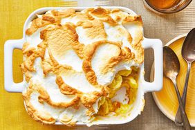 a square pan of banana pudding on a yellow linen