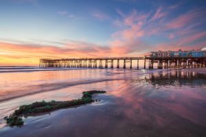 Cocoa Beach Florida with the Cocoa Pier in the background with a beautiful sunrise