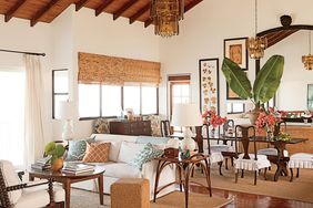 This St. Kitts great room features dark stained wood—a frequent feature of island design—but also retains an airy feeling thanks to its vaulted ceilings, creamy walls, and natural fiber rugs.