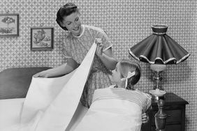 Vintage Mother and Daughter Making Bed