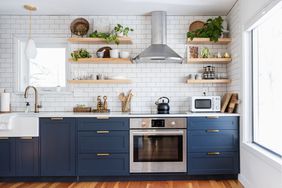 blue kitchen cabinets next with stainless steel range