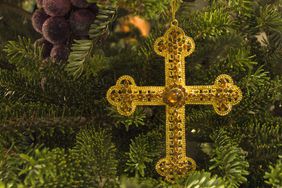 Gold Christmas ornament Chrismon Cross on the tree