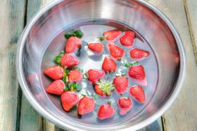 Strawberries Soaking in Water in Metal Bowl