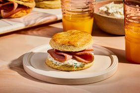 Ham Biscuits on white plate with cups of orange juice - Southern Living