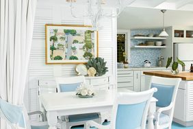 An open floorplan allows this dining room to live large, and white furniture and walls make it feel more spacious.