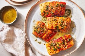 Southern Living Pan Seared Salmon topped with herb butter on a plate to serve