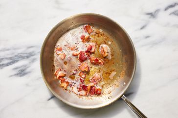 Southern Living Popcorn Salad cooking the bacon in a skillet