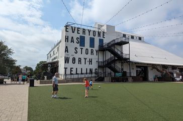 Side of Magnolia building that says, "Everyone Has A Story Worth Telling."