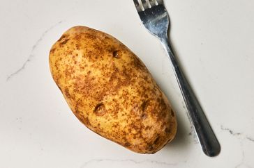 Southern Living Quick Baked Potato piercing the potato with a fork