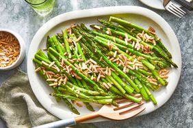 oven roasted asparagus on a white oval dish