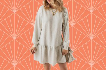 The Blencot Long-Sleeve Pullover Patchwork Sweater Mini Dress over a orange patterned background