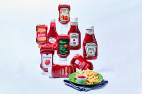 9 Bottles of Ketchup for Taste Test with plate of fries