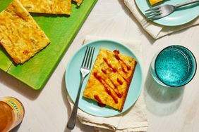 Southern Living Texas Torte cut on a plate, topped with hot sauce