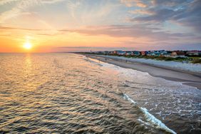 View of beach from Oak Island Pier at sunset, Oak Island